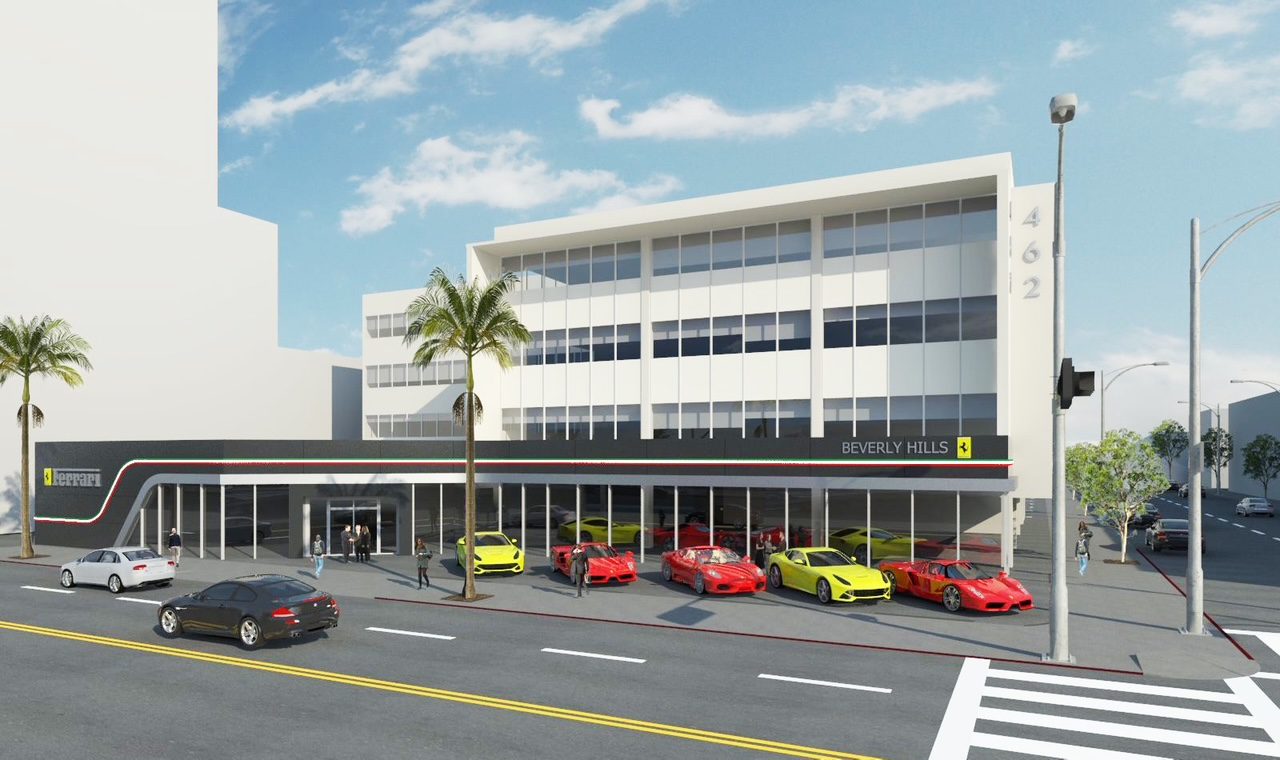 Modern building with several sports cars parked outside on a sunny day.