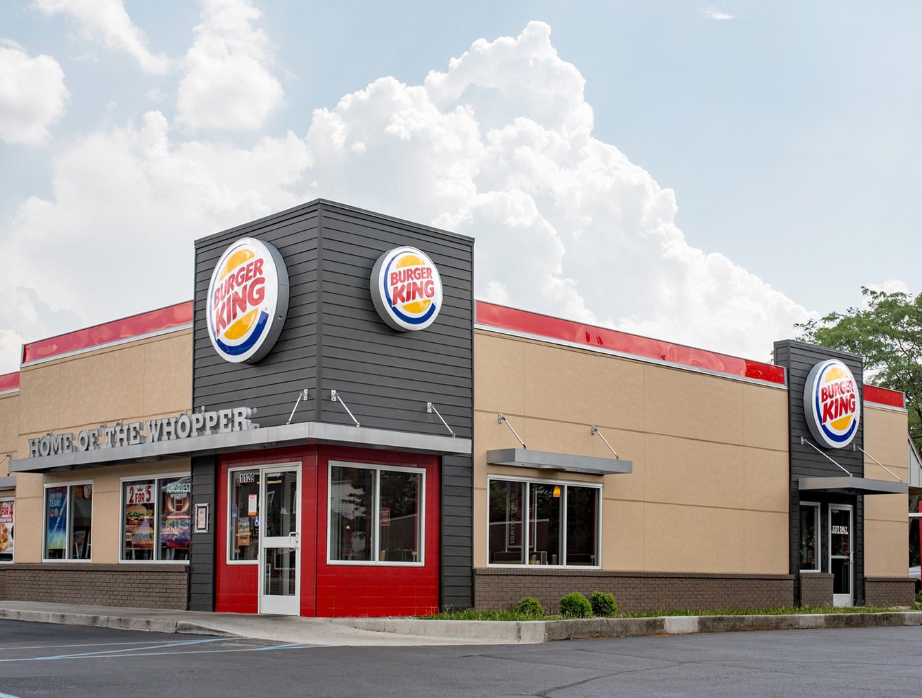 Burger King restaurant exterior with cloudy sky.